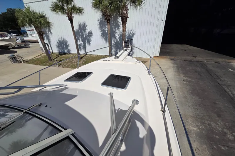 Reel Fun Yacht Photos Pics 2013 Grady-White Express 330 boat deck with palm trees and storage building.