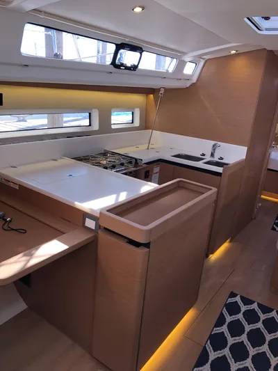  Yacht Photos Pics 2024 Jeanneau Sun Odyssey 440 interior with modern kitchen and sleek design.
