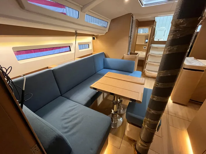  Yacht Photos Pics Interior of 2024 Jeanneau Sun Odyssey 440 yacht with modern seating and dining area.
