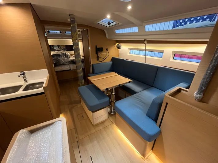  Yacht Photos Pics 2024 Jeanneau Sun Odyssey 440 interior with modern seating and dining area.