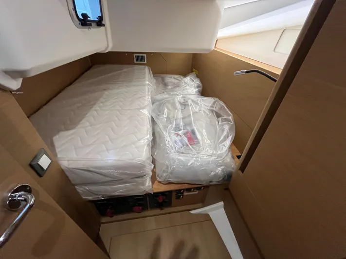  Yacht Photos Pics 2024 Jeanneau Sun Odyssey 440 cabin with mattress and wooden interior.