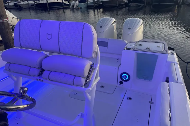  Yacht Photos Pics 2026 Sea Fox 268 Commander boat interior with illuminated seating and dual engines at a marina.