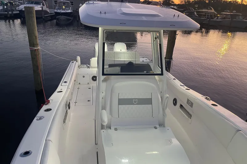  Yacht Photos Pics 2026 Sea Fox 268 Commander boat interior at sunset, docked in marina.