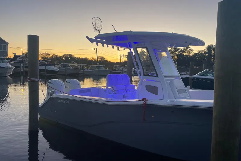 Yacht Photos Pics 2026 Sea Fox 268 Commander boat docked at sunset with blue interior lighting.