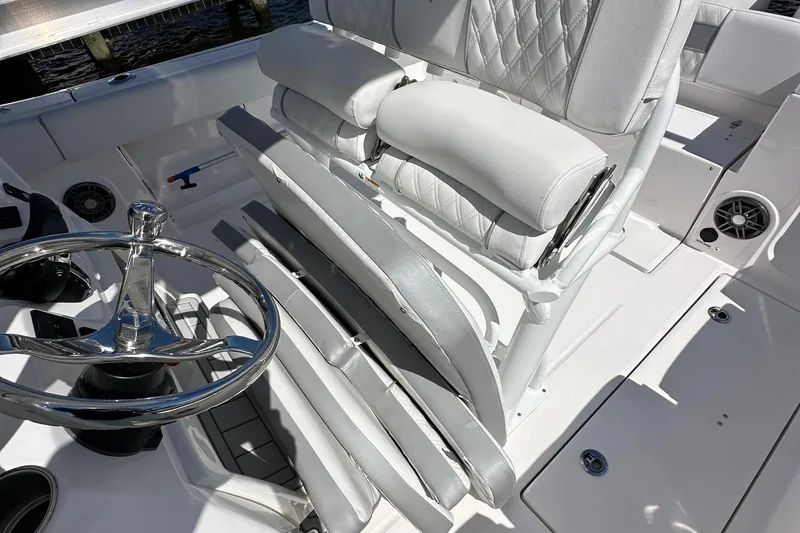  Yacht Photos Pics 2026 Sea Fox 268 Commander boat interior with steering wheel and cushioned seating.