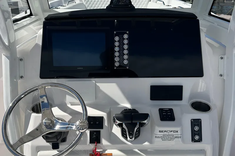  Yacht Photos Pics 2026 Sea Fox 268 Commander dashboard with steering wheel and electronic controls.