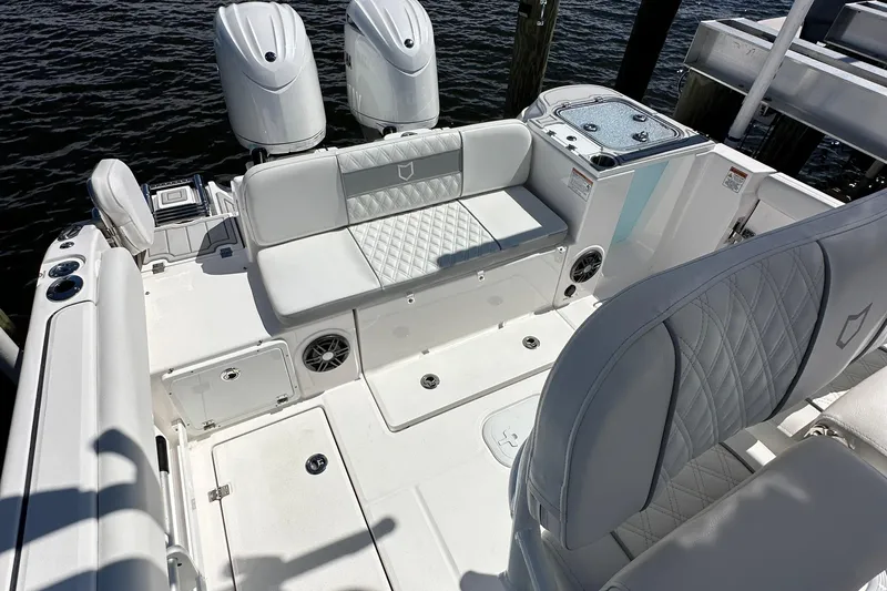  Yacht Photos Pics 2026 Sea Fox 268 Commander boat interior with white seating and dual outboard motors.