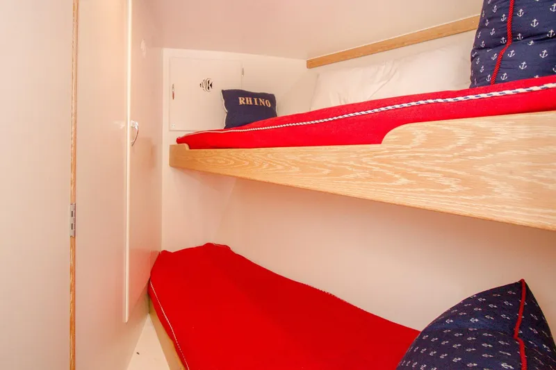 Rhino Yacht Photos Pics Cozy bunk beds with red bedding in a 1958 Rybovich 54 Yachtfish cabin.