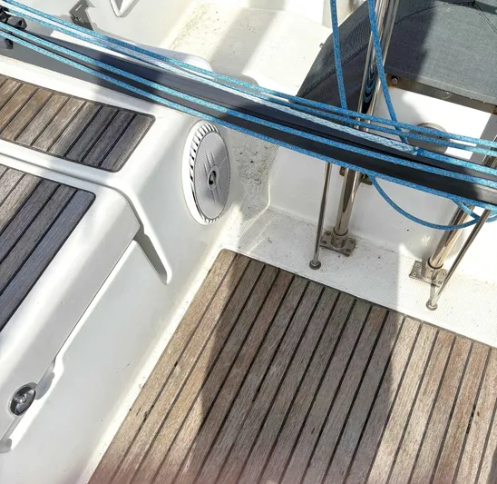 Brown Sugar Yacht Photos Pics Cockpit of 2005 Beneteau First 47.7 sailboat with teak flooring and blue ropes.