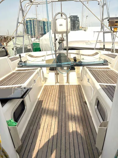 Brown Sugar Yacht Photos Pics Beneteau First 47.7 sailboat cockpit, 2005 model, featuring teak flooring and modern design.