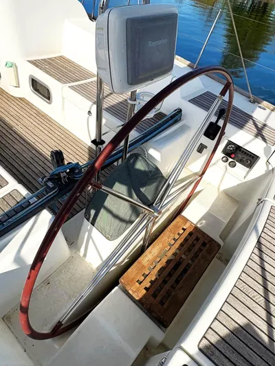 Brown Sugar Yacht Photos Pics Cockpit of 2005 Beneteau First 47.7 sailboat with wooden steering wheel.
