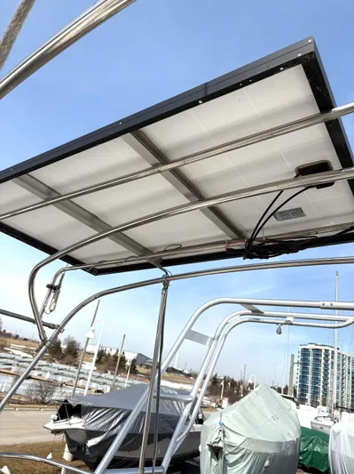 Brown Sugar Yacht Photos Pics Solar panel on a 2005 Beneteau First 47.7 sailboat, docked with covered boats nearby.