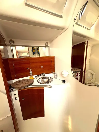 Brown Sugar Yacht Photos Pics Interior of 2005 Beneteau First 47.7 yacht bathroom with sink and mirror.