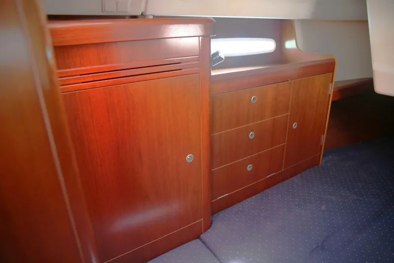 Brown Sugar Yacht Photos Pics Interior cabin of 2005 Beneteau First 47.7 yacht with wooden cabinetry and drawers.