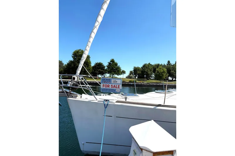 Brown Sugar Yacht Photos Pics 2005 Beneteau First 47.7 sailboat for sale, docked in a marina under clear blue skies.