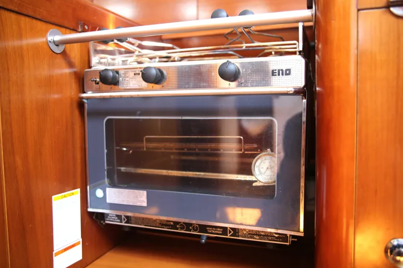 Brown Sugar Yacht Photos Pics Galley oven in 2005 Beneteau First 47.7 yacht, featuring wooden cabinetry.
