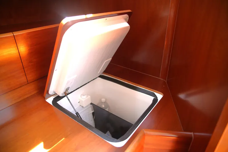 Brown Sugar Yacht Photos Pics Interior view of a 2005 Beneteau First 47.7 yacht with an open storage compartment.