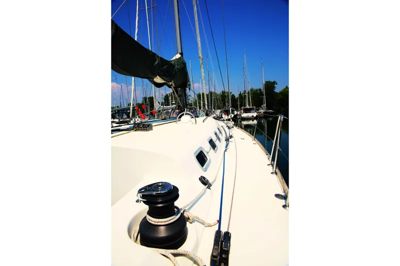 Brown Sugar Yacht Photos Pics Sailing yacht Beneteau First 47.7, 2005 model, docked in a marina under clear blue skies.