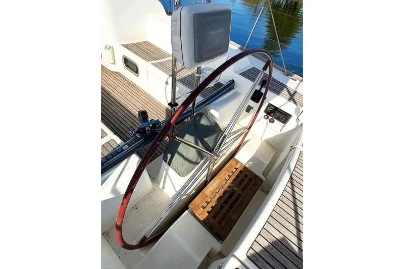 Brown Sugar Yacht Photos Pics Cockpit of 2005 Beneteau First 47.7 sailboat with wooden wheel and navigation equipment.