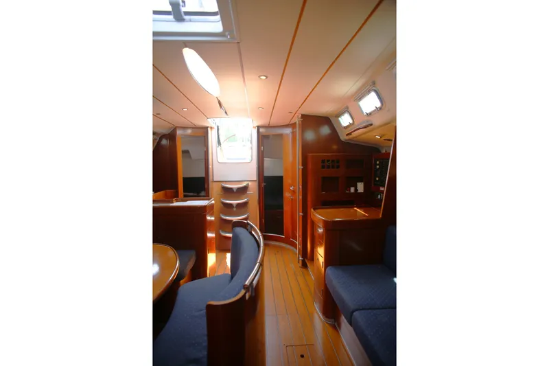 Brown Sugar Yacht Photos Pics Interior of 2005 Beneteau First 47.7 yacht, featuring elegant wood finishes and seating.