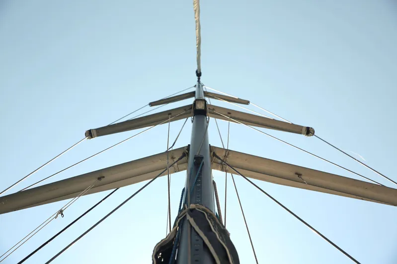 Brown Sugar Yacht Photos Pics Mast of 2005 Beneteau First 47.7 sailboat against clear blue sky.