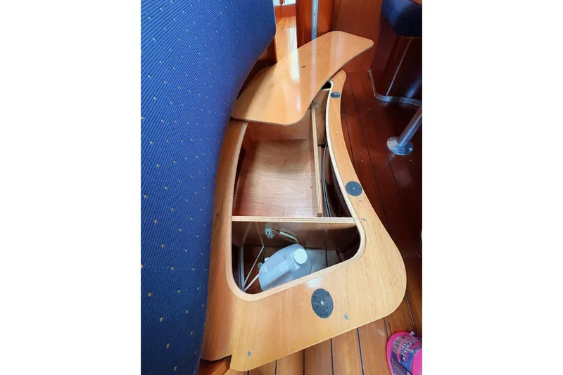 Brown Sugar Yacht Photos Pics Interior view of a 2005 Beneteau First 47.7 sailboat, showcasing wooden storage compartment.