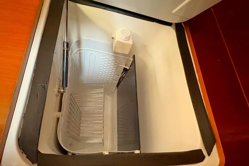 Brown Sugar Yacht Photos Pics Open storage compartment on 2005 Beneteau First 47.7 yacht, featuring a metal rack and latch.