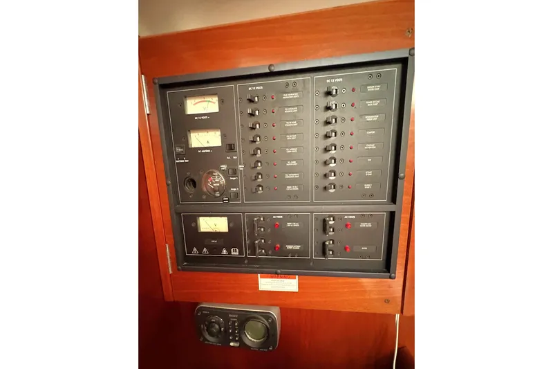 Brown Sugar Yacht Photos Pics Electrical control panel on a 2005 Beneteau First 47.7 yacht, featuring various switches and gauges.