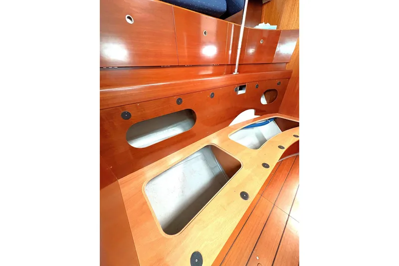 Brown Sugar Yacht Photos Pics Interior view of 2005 Beneteau First 47.7 sailboat, showcasing wooden storage compartments.