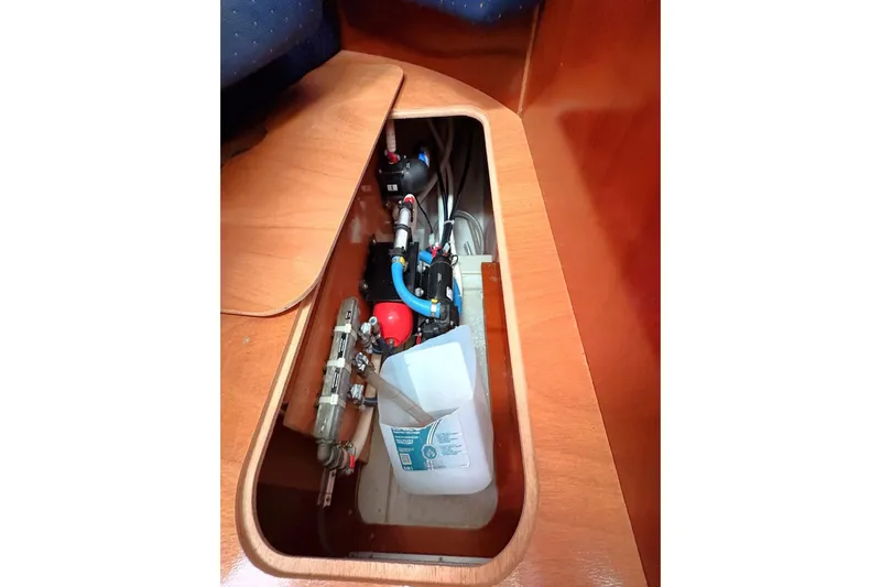 Brown Sugar Yacht Photos Pics Storage compartment in 2005 Beneteau First 47.7 yacht, showcasing plumbing and equipment.