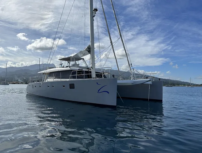 Zahora Yacht Photos Pics 2008 Sunreef 62 catamaran on calm water under a partly cloudy sky.