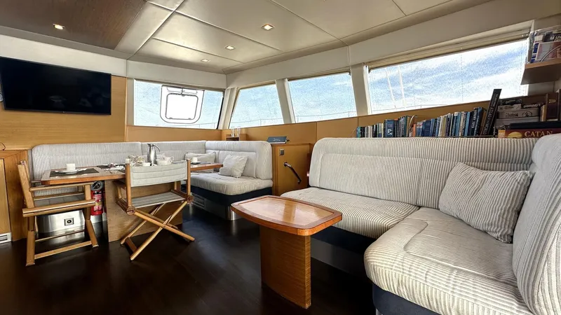 Zahora Yacht Photos Pics Luxurious interior of 2008 Sunreef 62 yacht with striped seating and large windows.