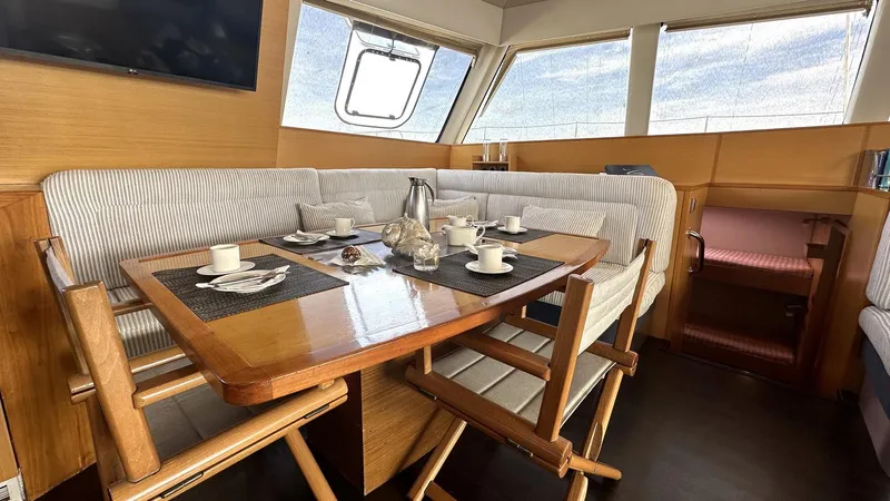 Zahora Yacht Photos Pics Interior dining area of 2008 Sunreef 62 yacht with table and chairs.
