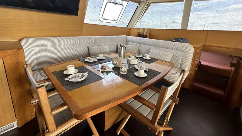 Zahora Yacht Photos Pics Interior of 2008 Sunreef 62 yacht with dining table and seating area.