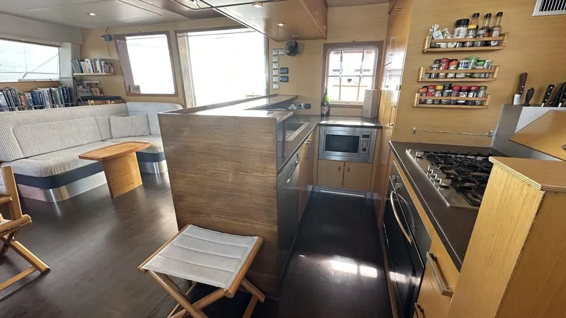 Zahora Yacht Photos Pics Interior of 2008 Sunreef 62 yacht with modern kitchen and cozy seating area.