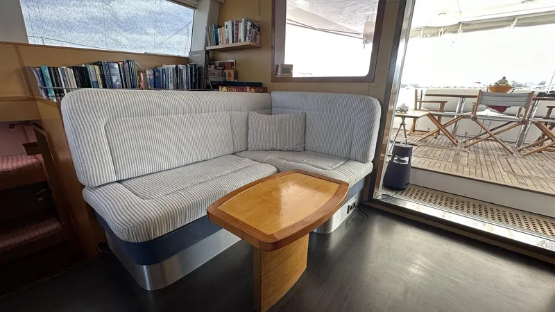 Zahora Yacht Photos Pics Interior of 2008 Sunreef 62 yacht with cozy seating and wooden table.