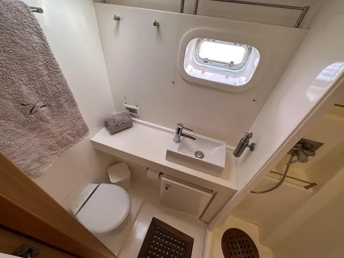 Zahora Yacht Photos Pics Luxurious bathroom in 2008 Sunreef 62 yacht with modern fixtures and porthole window.