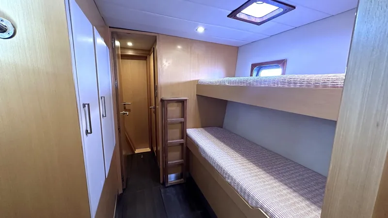 Zahora Yacht Photos Pics Interior of 2008 Sunreef 62 yacht with bunk beds and wooden cabinetry.