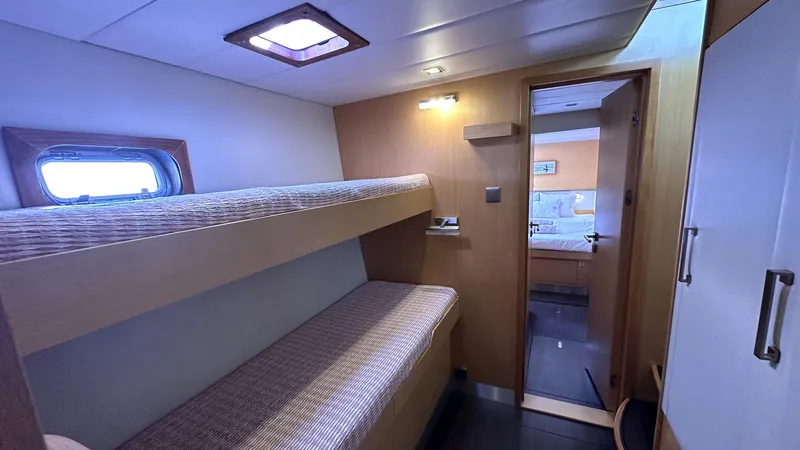 Zahora Yacht Photos Pics 2008 Sunreef 62 yacht cabin with bunk beds and wooden interior.