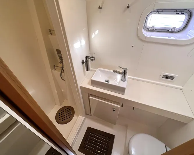 Zahora Yacht Photos Pics Luxurious bathroom in 2008 Sunreef 62 yacht with shower, sink, and porthole window.