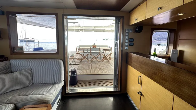 Zahora Yacht Photos Pics Interior of 2008 Sunreef 62 yacht with cozy seating and outdoor dining area.