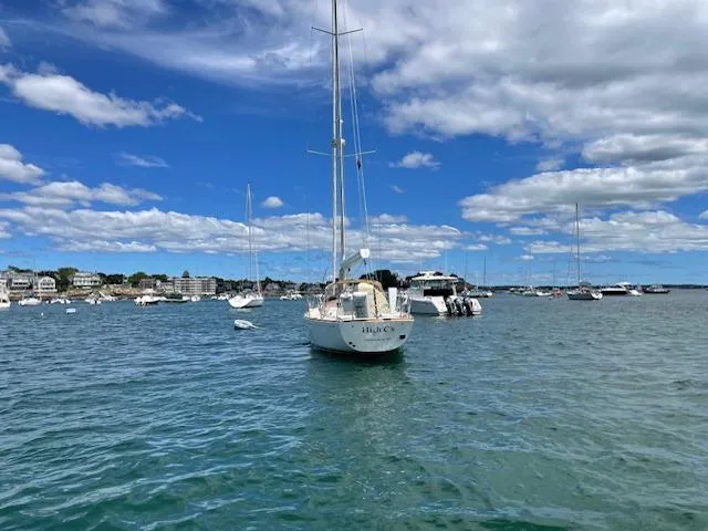 High C's Yacht Photos Pics Sailboat on calm water under blue sky, Sabre Spirit 2012 model.