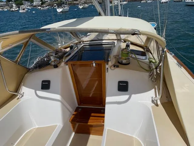 High C's Yacht Photos Pics Cockpit of 2012 Sabre Spirit sailboat with beige canopy, docked in a marina.