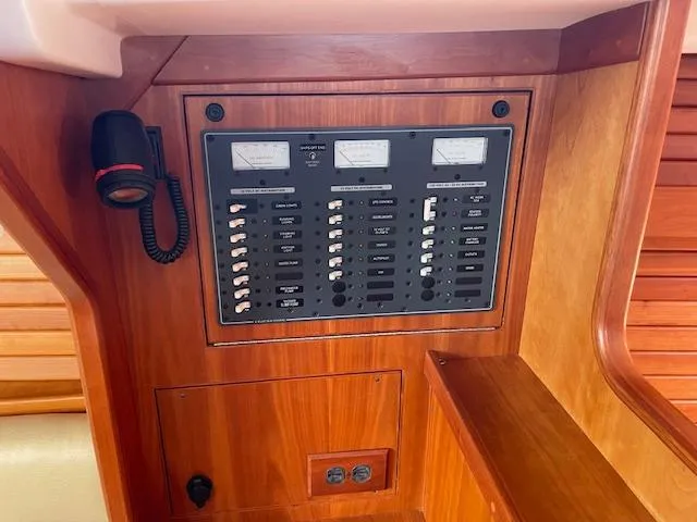 High C's Yacht Photos Pics Electrical panel on 2012 Sabre Spirit boat, featuring switches and meters in a wooden interior.