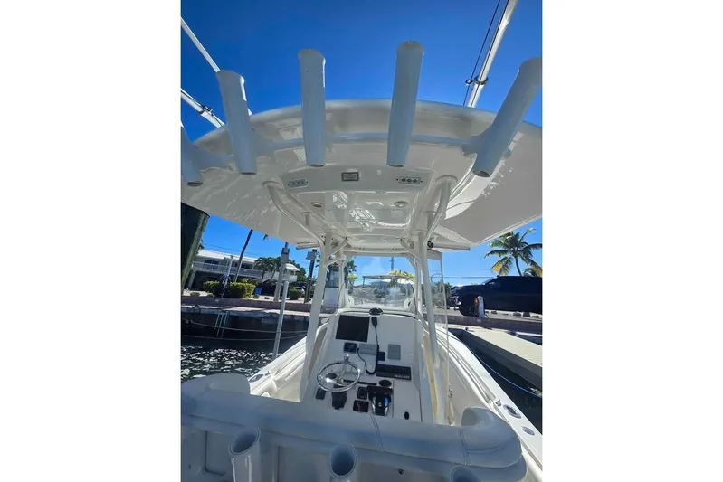  Yacht Photos Pics 2017 Regulator 25 boat interior with helm, rod holders, and clear blue sky.