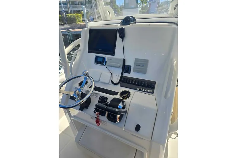  Yacht Photos Pics 2017 Regulator 25 boat dashboard with steering wheel and Garmin navigation system.