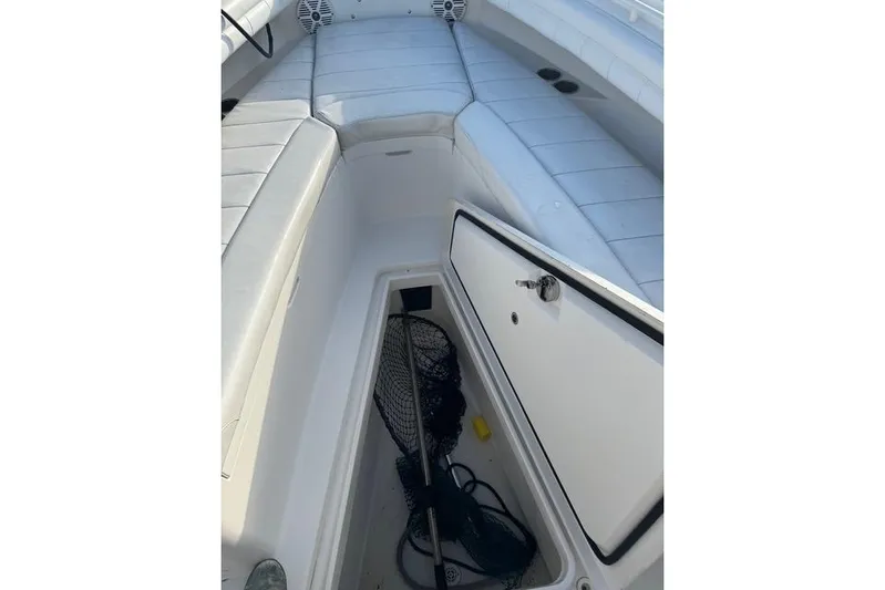  Yacht Photos Pics 2017 Regulator 25 boat interior with open storage compartment and fishing gear.