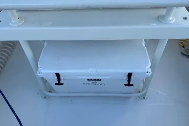  Yacht Photos Pics 2017 Regulator 25 boat with a white cooler secured under a bench.