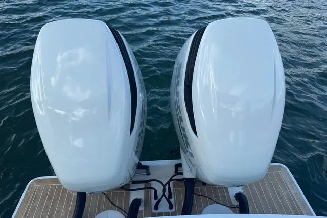  Yacht Photos Pics Twin outboard motors on a 2017 Regulator 25 boat, floating on water.