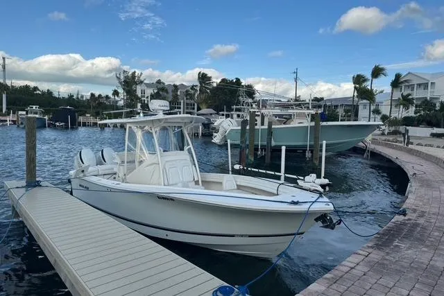  Yacht Photos Pics 2017 Regulator 25 boat docked at marina with clear skies and waterfront homes.
